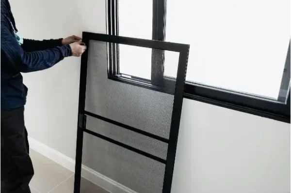 Worker Installing Window Screens