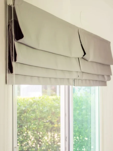 Roman blinds on window